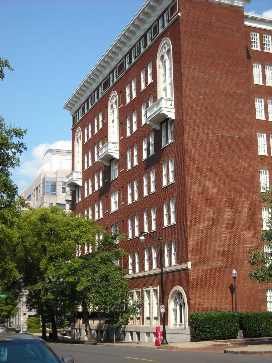 Tutwiler Hotel in Birmingham, red-brick corner, white window trim, and the arched street-level opening