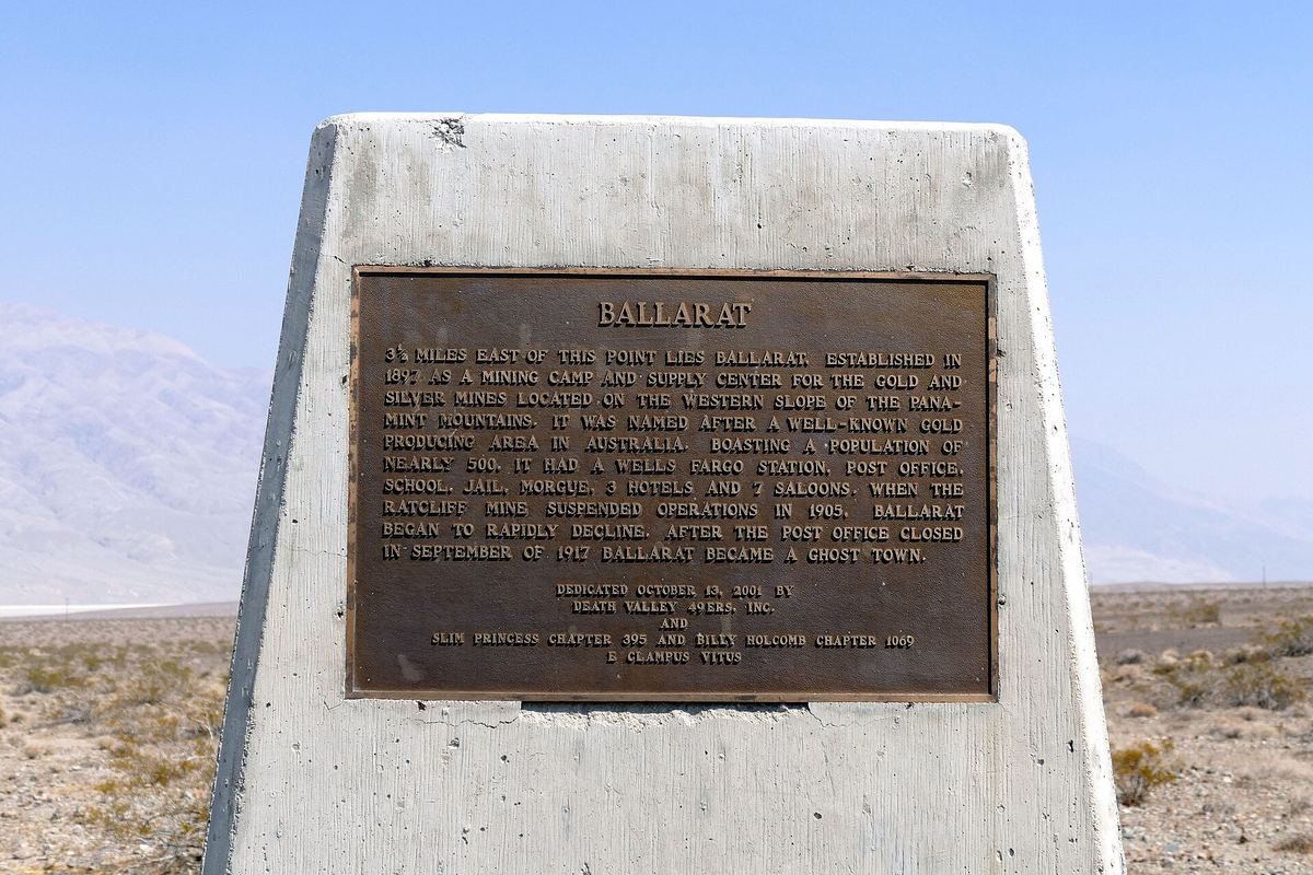 Bronze historical marker for Ballarat with the Panamint Valley desert behind it