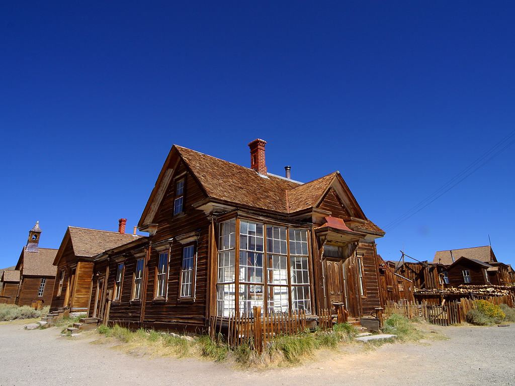 Weathered two-story wooden house with a bay window at Bodie State Historic Park
