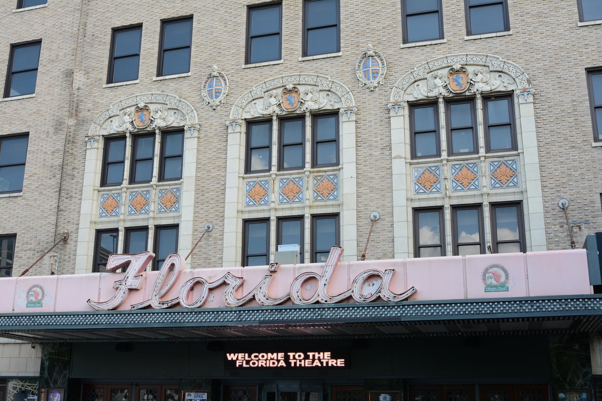 Florida Theatre in Jacksonville, the brick front, the script sign reading Florida, the lighted welcome line, and the doors under the board