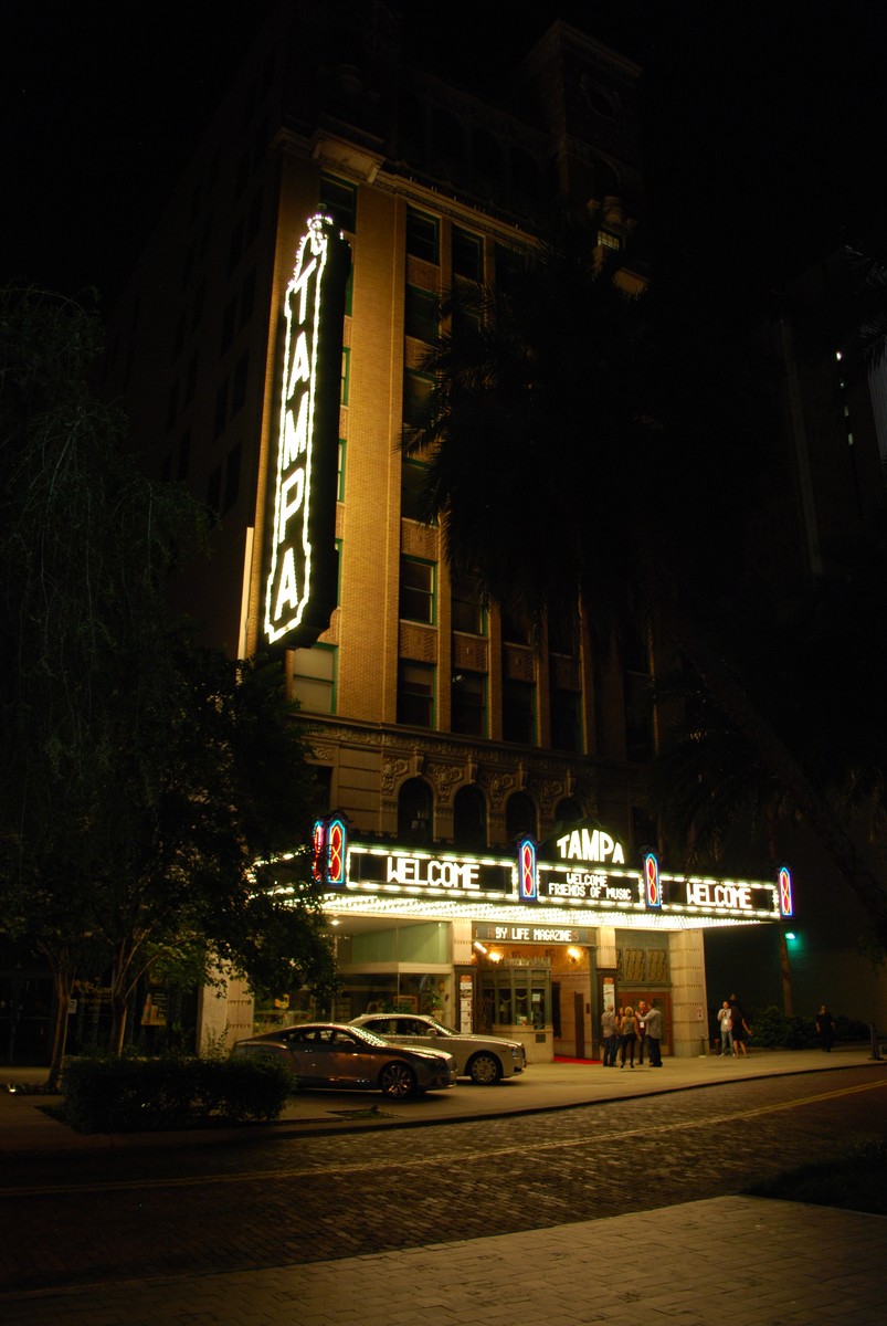 Tampa Theatre in Tampa, the night front, the vertical sign reading TAMPA, the marquee, and the doors under the lights