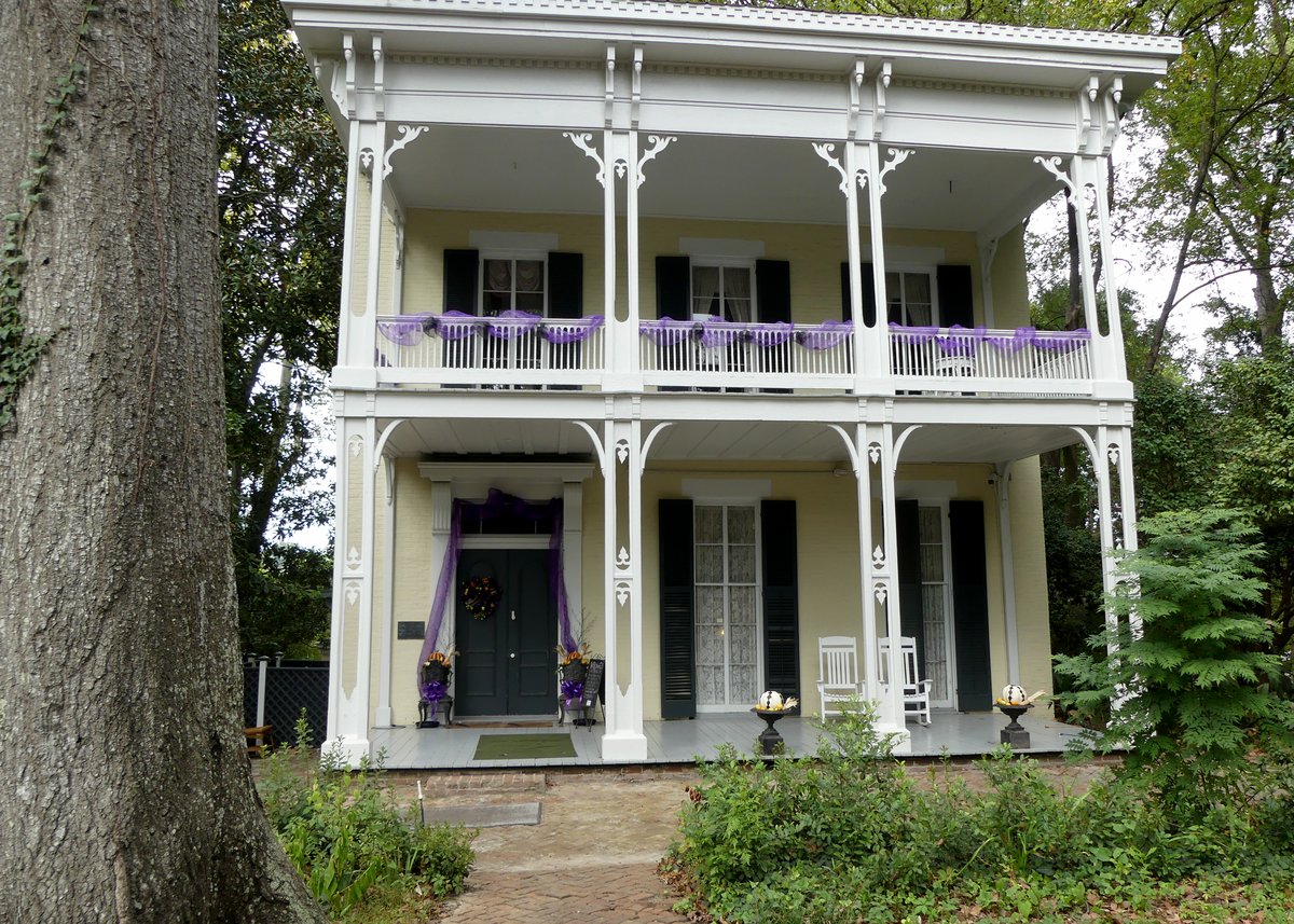 McRaven House in Vicksburg, pale two-story house, white porches, and the dark door