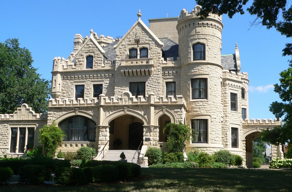 Joslyn Castle in Omaha, stone mansion with a round tower and arched porch