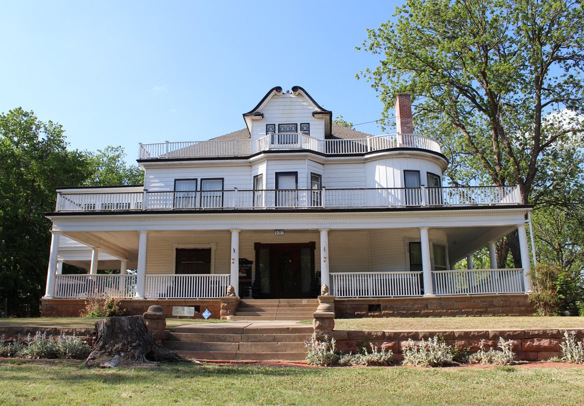 Stone Lion Inn in Guthrie, white porch and center doors