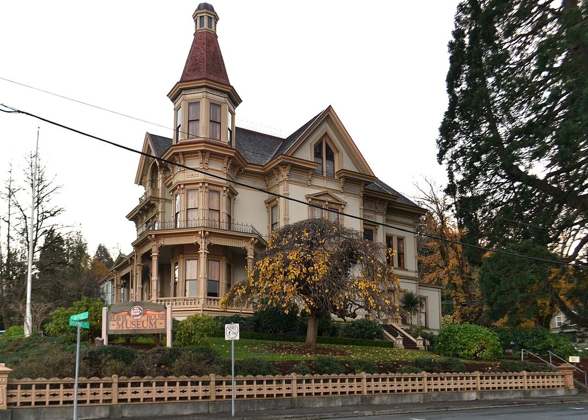 The Queen Anne style Flavel House in Astoria, Oregon, with its tall octagonal tower and wraparound porch