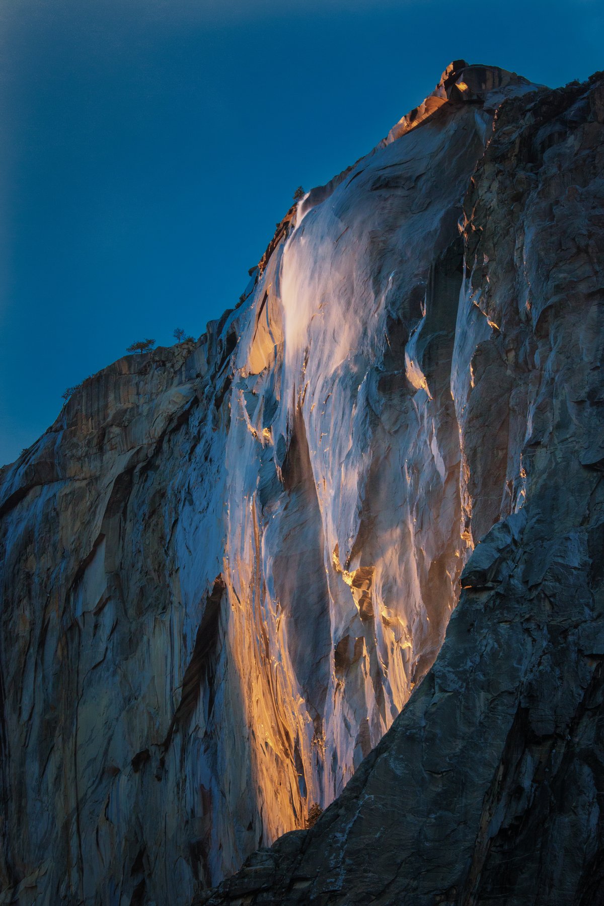 Horsetail Fall on El Capitan glowing orange at sunset, the Yosemite firefall